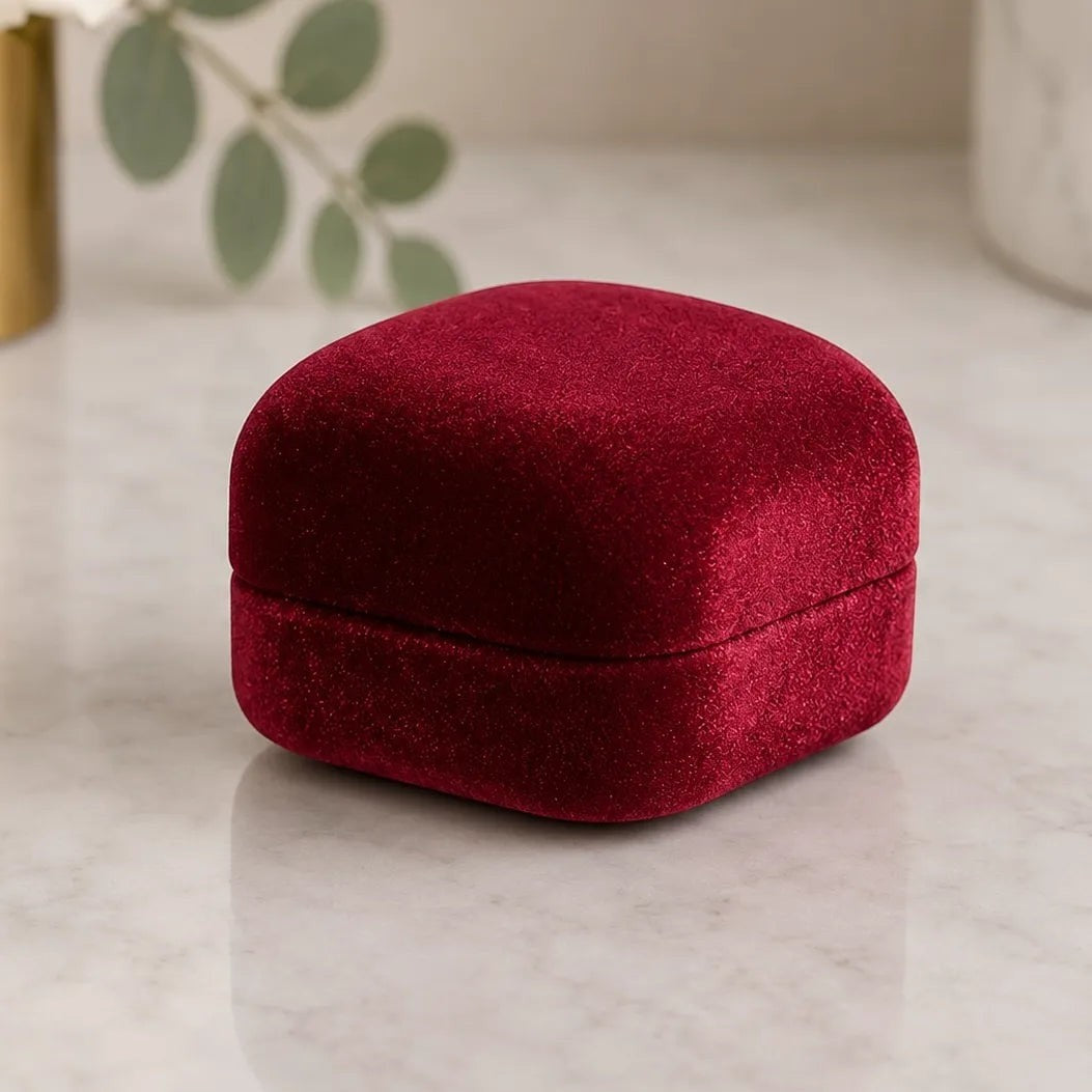 AtelierRings Mayfair ring box in deep red velvet with a soft, sculpted silhouette for elegant jewelry presentation.